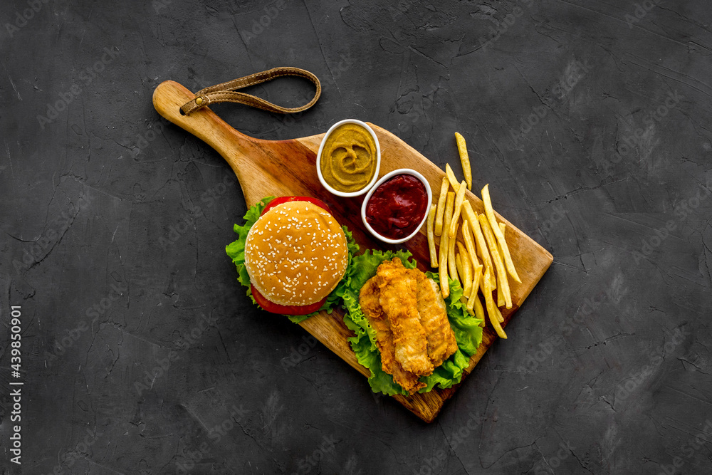 Delicious burgers with french fries and fried chicken. Flat lay, top view