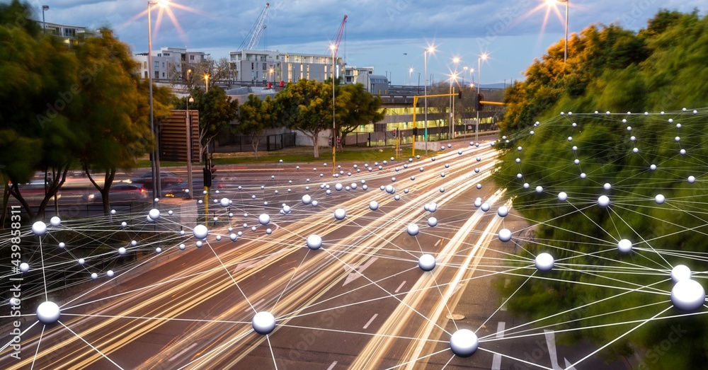 Network of connections against view of night city traffic