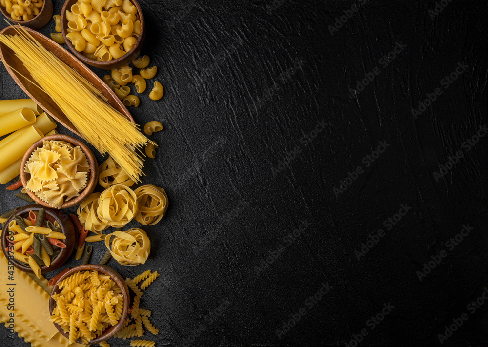 Different pasta types on blue background, top view