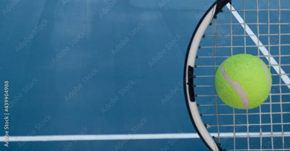 Composition of tennis ball and racket with copy space on tennis court