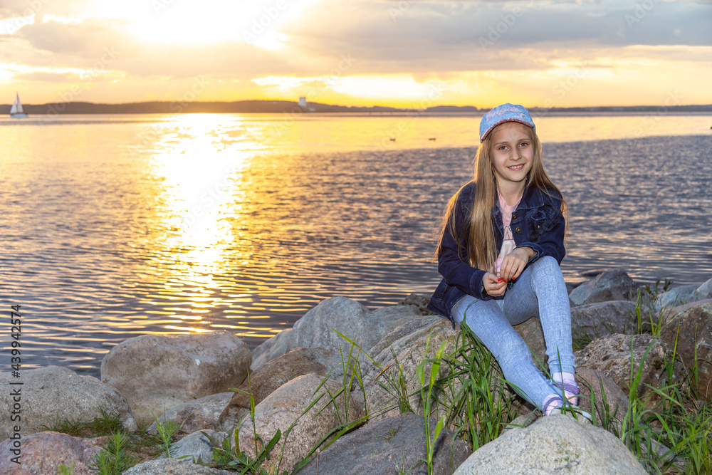 Smiling girl. Seaside and sunset view background.