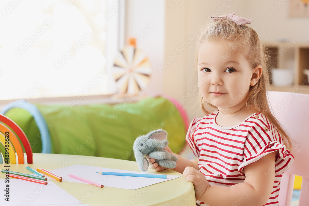 Little girl with toy at home