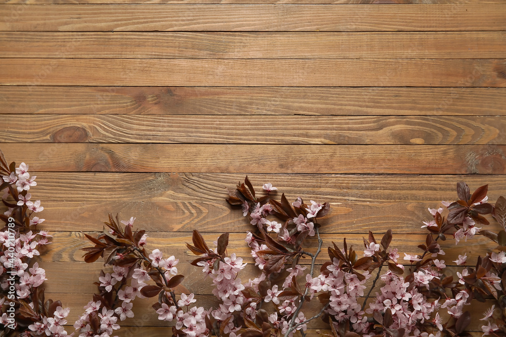 Beautiful blossoming branches on wooden background