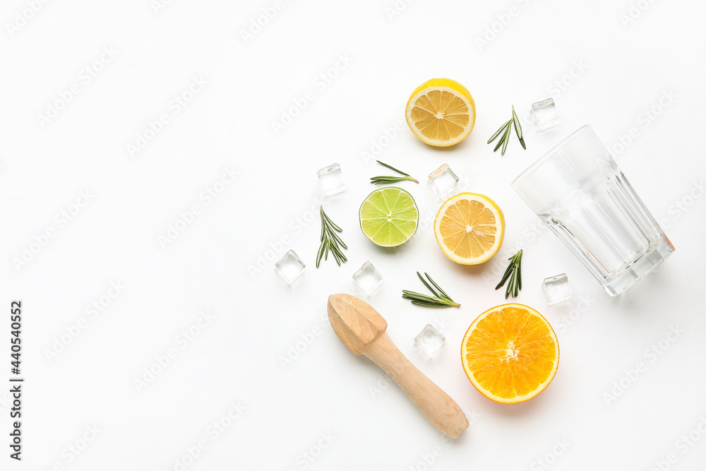 Composition with glass and healthy citrus fruits on white background