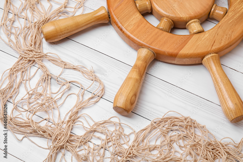 Helm and net on white wooden background