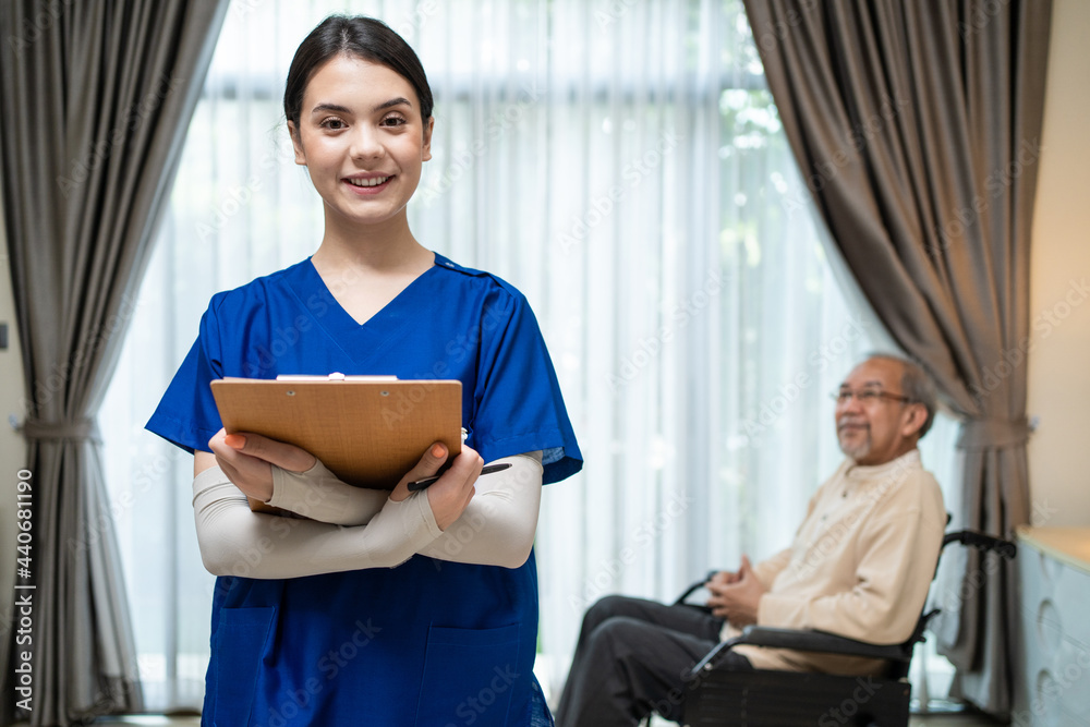 Beautiful nurse look at camera after visit older patient on wheelchair