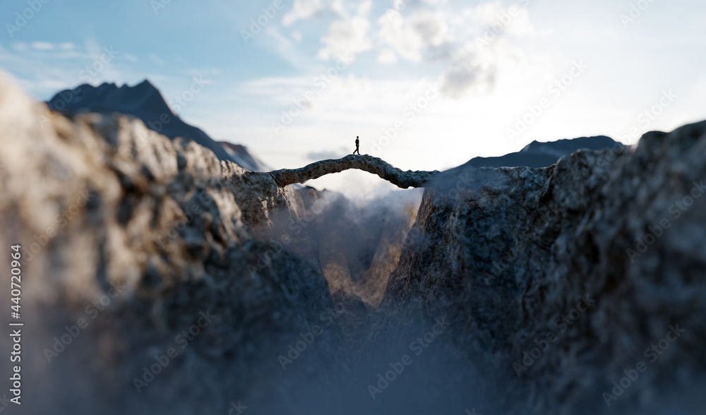 Man walking on the other side of mountain bridge.