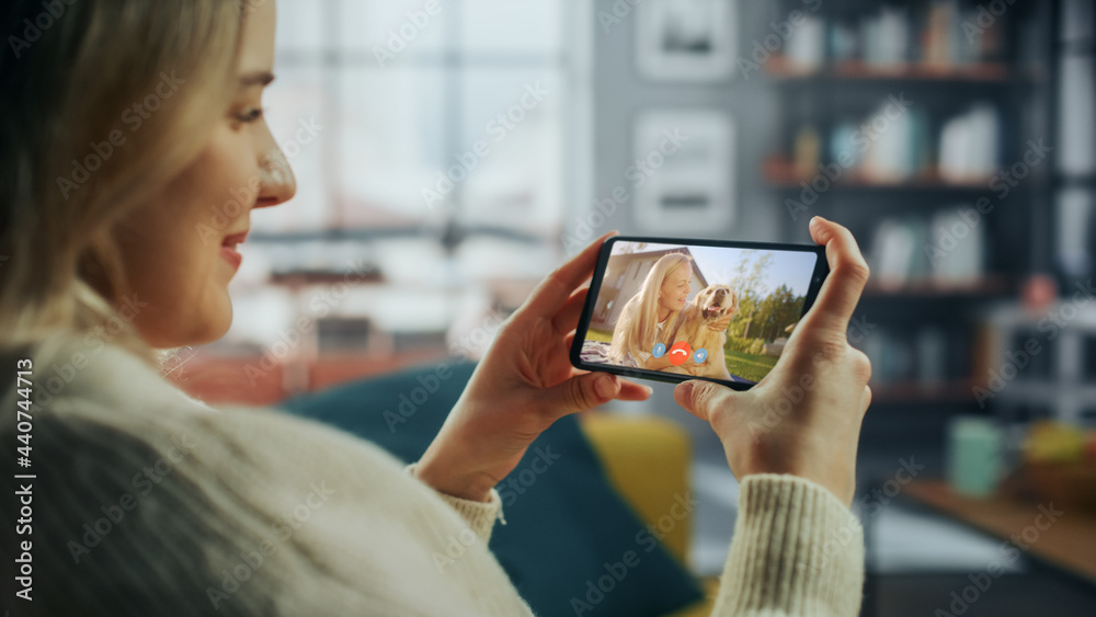 Close Up of a Female Chatting in a Video Call with Her Beautiful Friend Playing with a Dog on Smartp