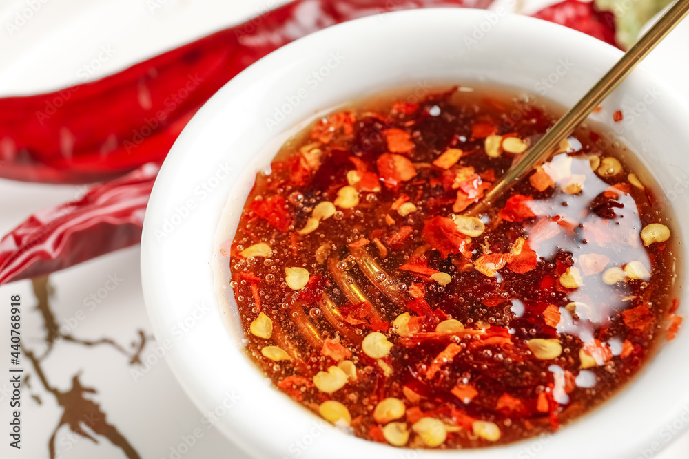 Bowl with hot honey on table, closeup