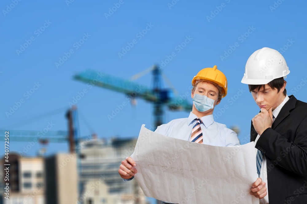 Construction Site Engineer And Building Inspection holding documents.