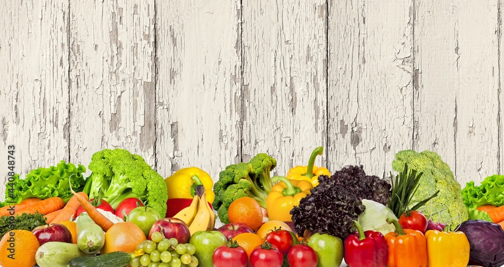 Panorama fruits, vegetables, berries on green blurred background