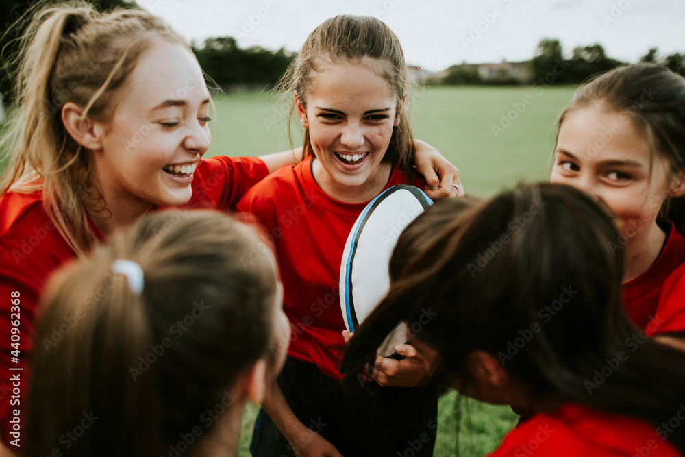 Cheerful young rugby players on the field