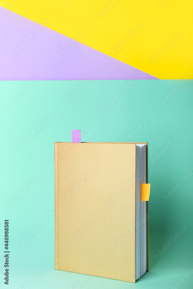 Book with bookmarks on color background