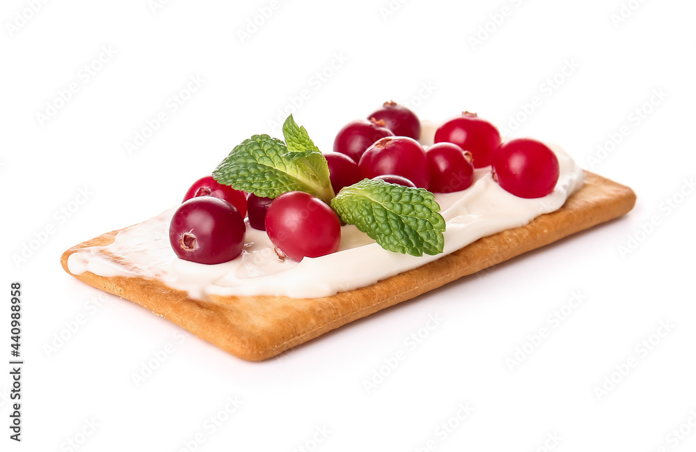 Tasty cracker with cheese and cranberry on white background