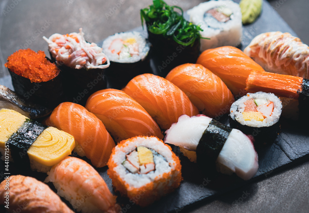 Salmon Sashimi in Japanese buffet restaurant menu.Fresh salmon fillet on black plate salmon slices.A