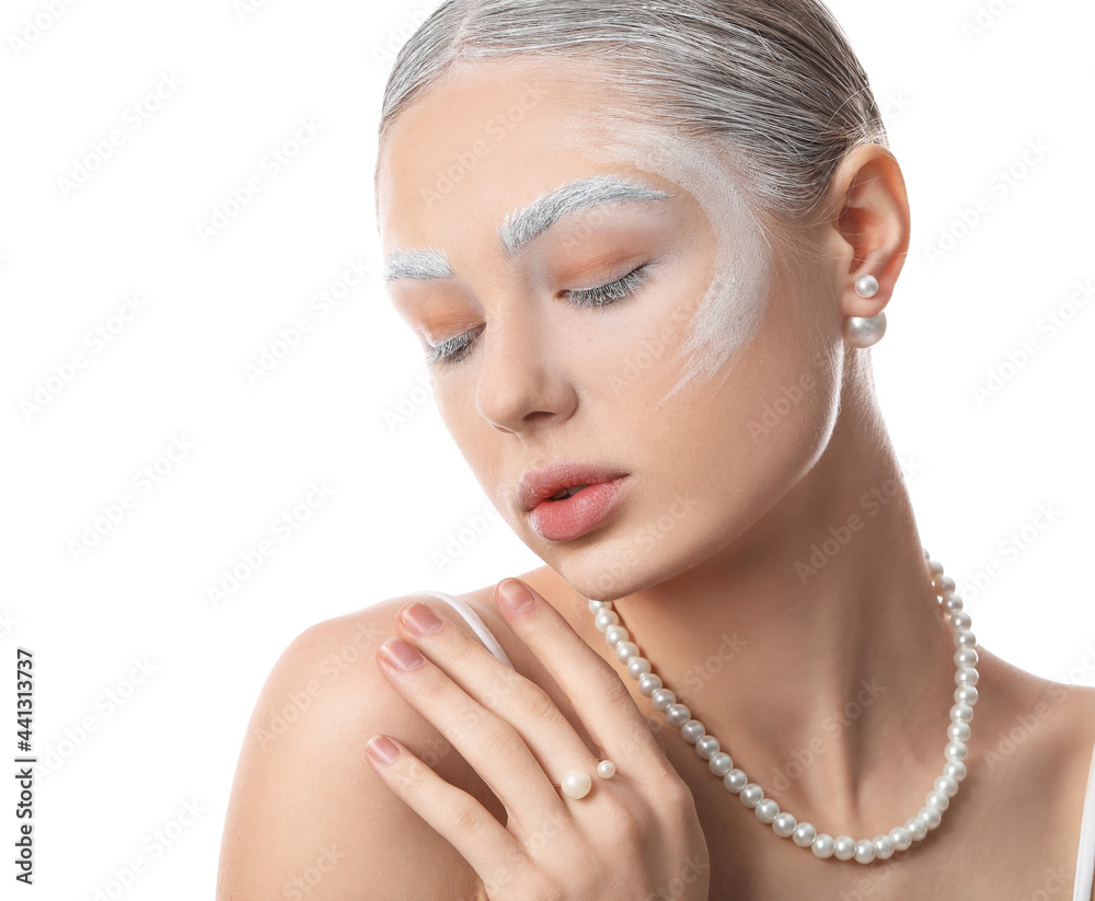 Beautiful young woman with dyed eyebrows and stylish necklace on white background