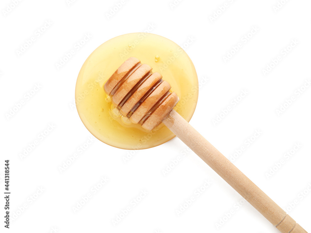 Wooden dipper and spilled honey on white background