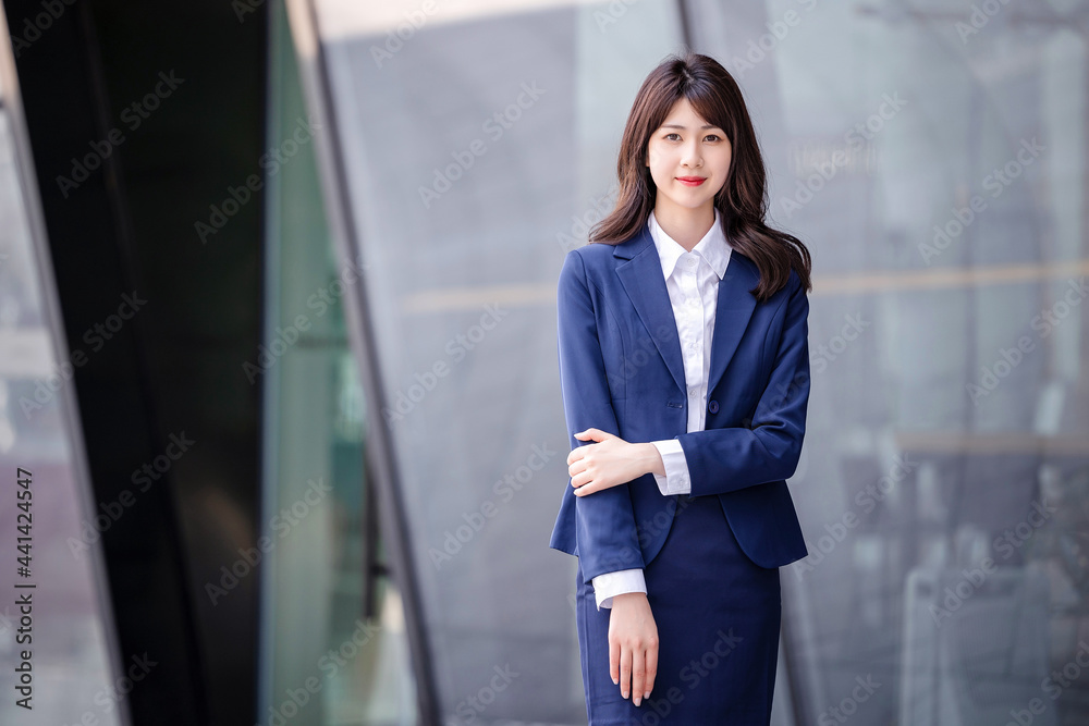 Beautiful Asian woman outdoors, wearing a suit