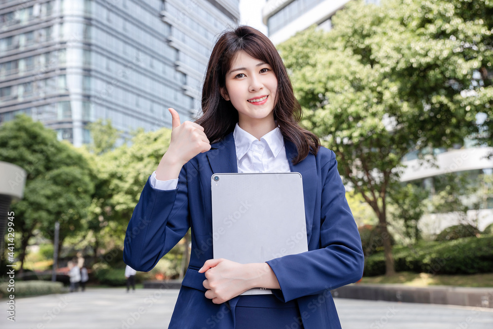 Beautiful Asian woman outdoors, wearing a suit