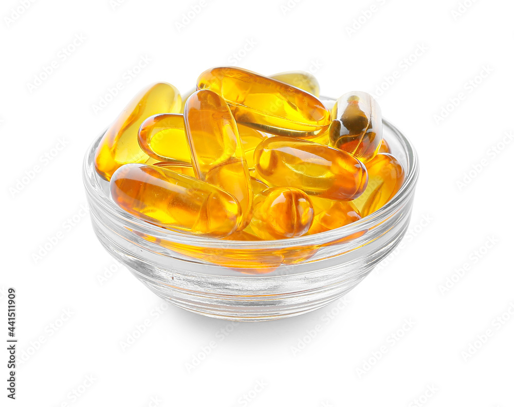 Bowl with fish oil capsules on white background