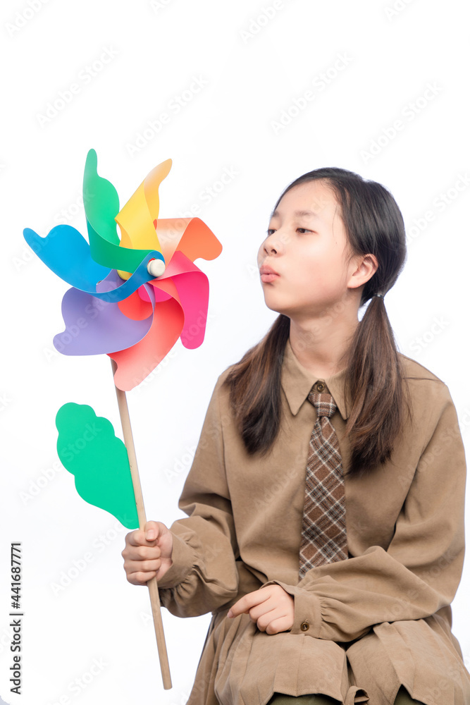 Asian little girl holding a windmill on white background