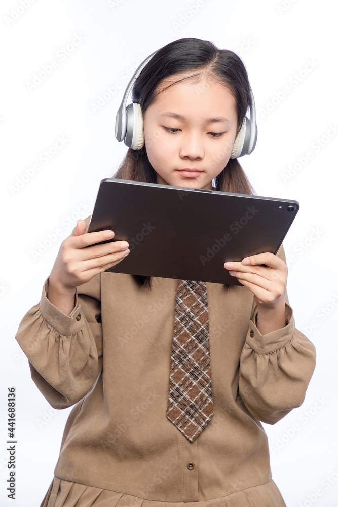 Asian little girl using a tablet on white background