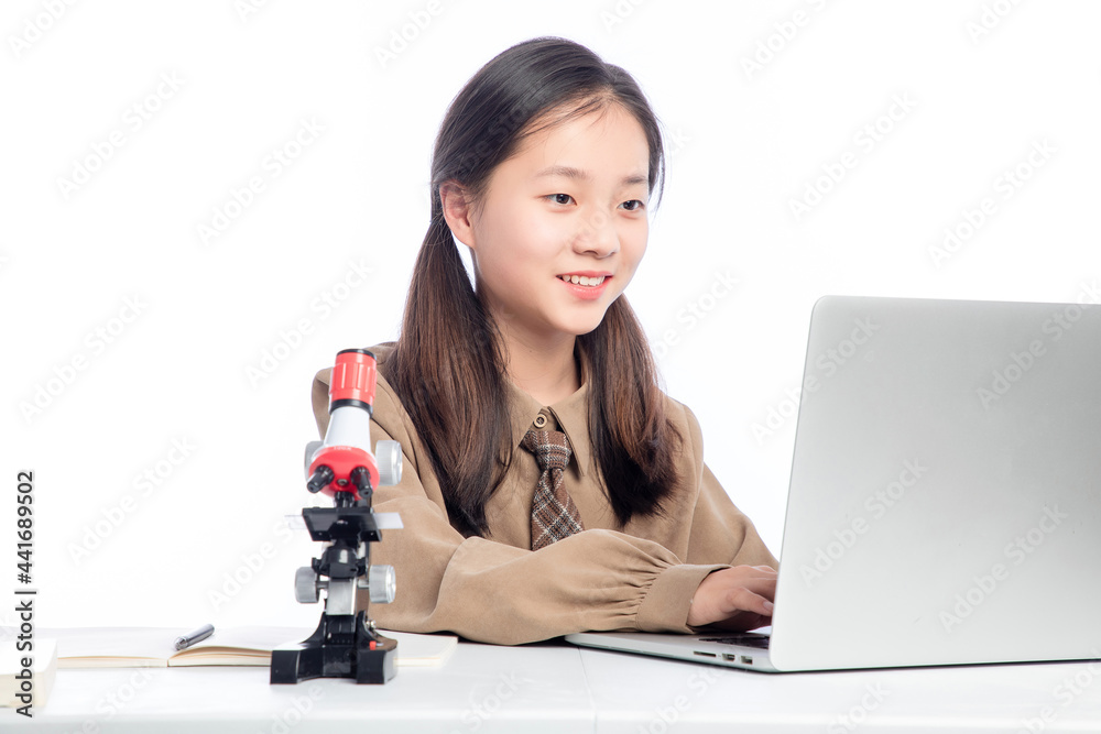 Little Asian girl receiving online education on white background