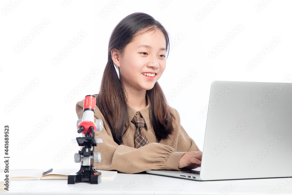 Little Asian girl receiving online education on white background