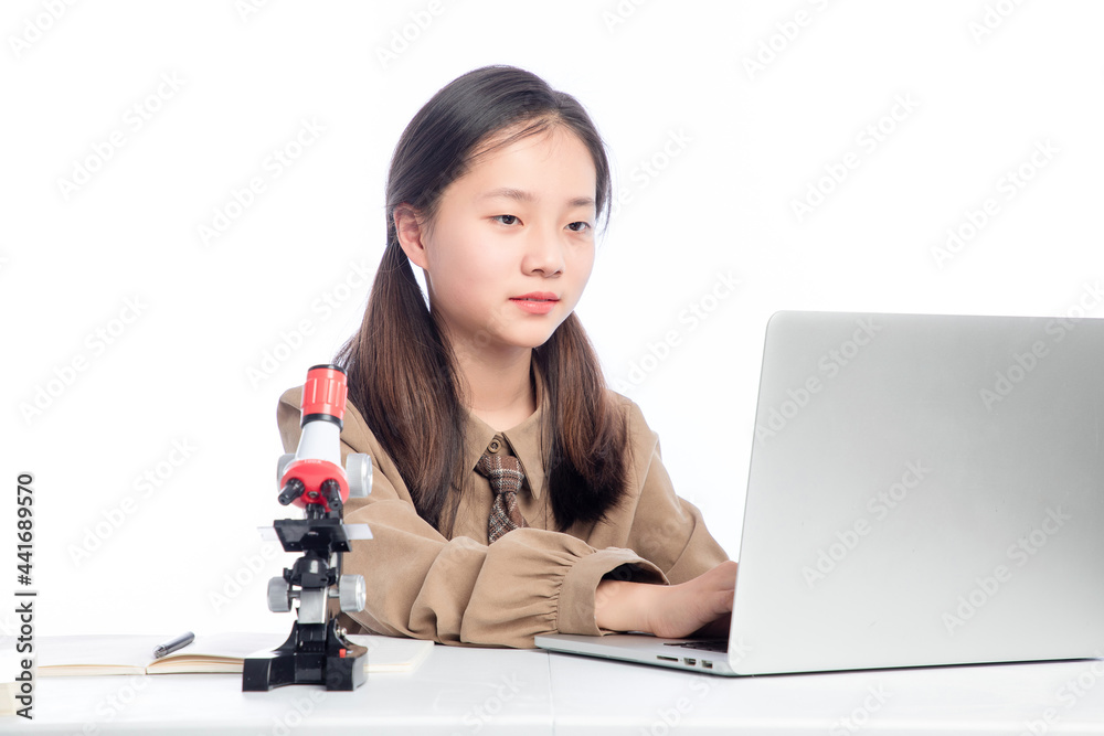 Little Asian girl receiving online education on white background