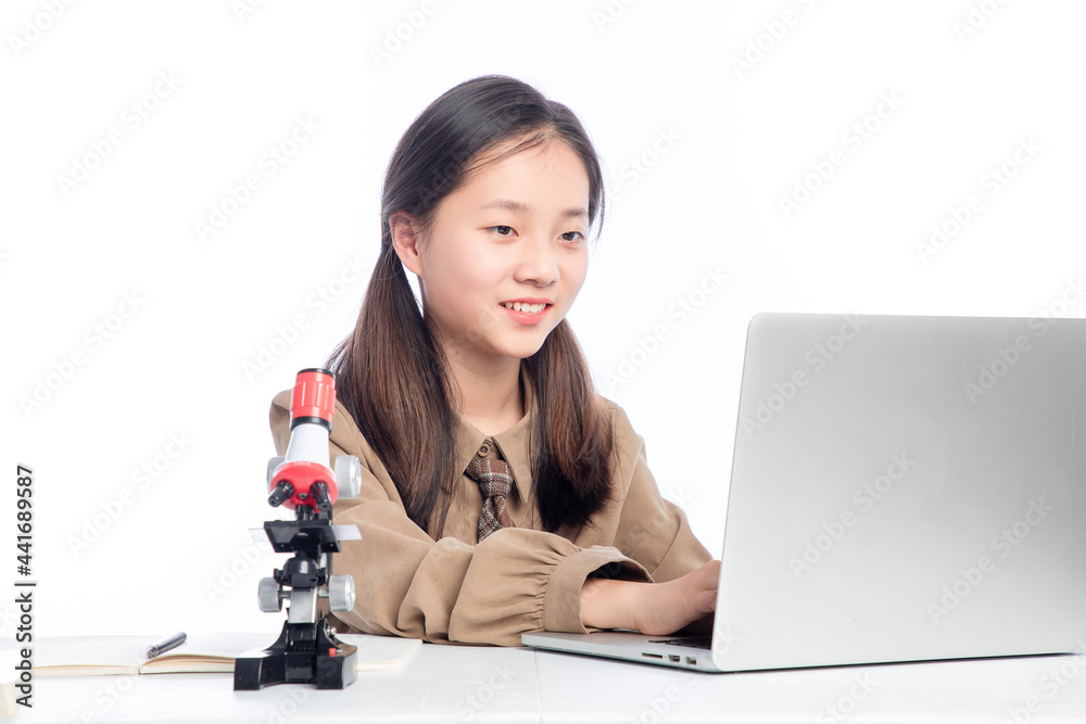 Little Asian girl receiving online education on white background