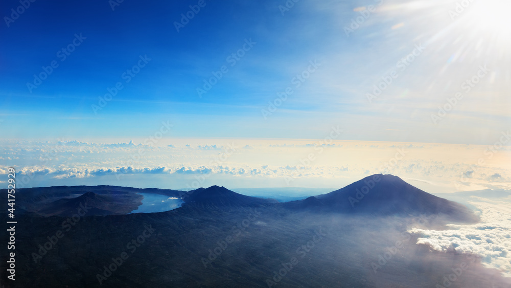 View from airplane window. Aerial photo of Agung - highest peak of island Bali, mount Abang, active 