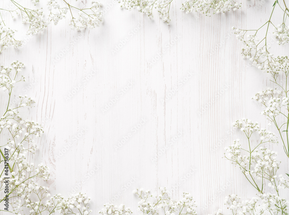 Flowers composition. White flowers on white background. Wedding mockup with small flowers. Flat lay,