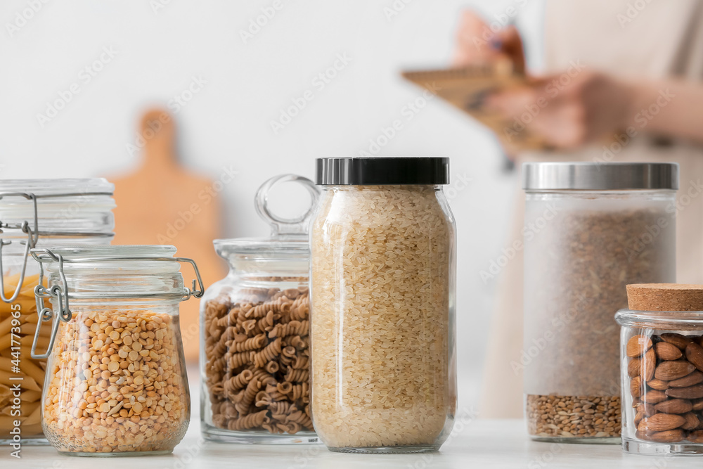 Jars with different products on table in kitchen