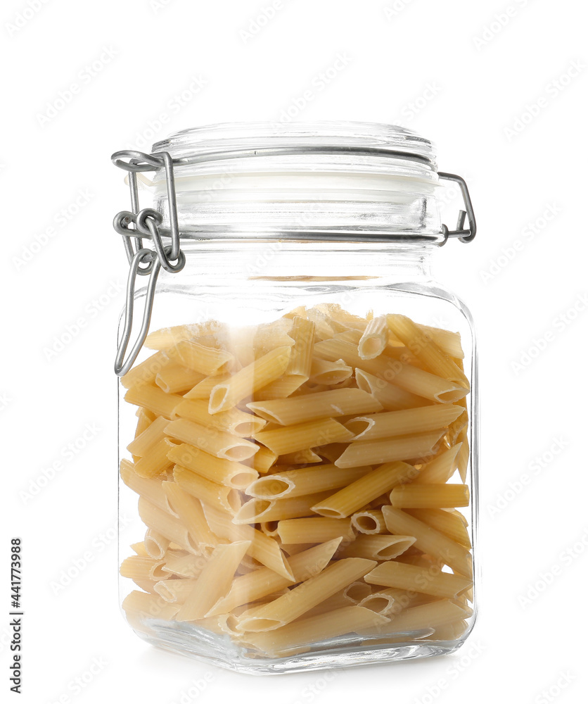 Glass jar with raw pasta on white background