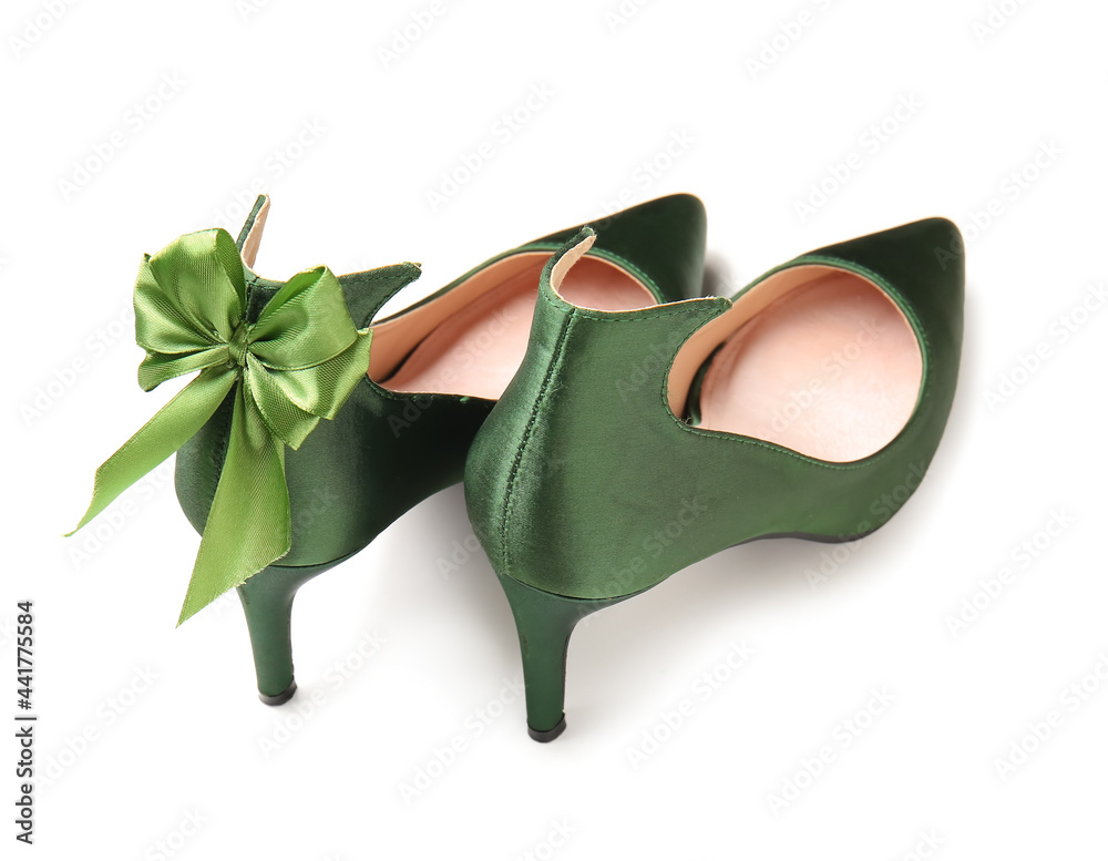 Stylish green shoes with bow on white background