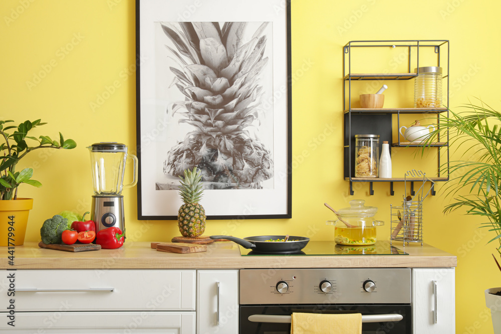 Modern electric stove and utensils in kitchen