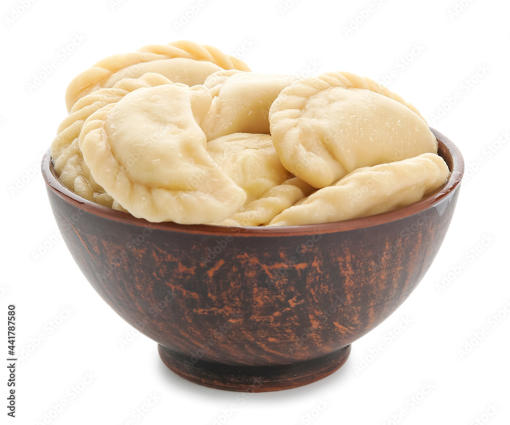 Bowl with tasty dumplings on white background