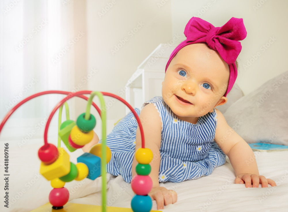 Infant girl play with bead roller coaster toy