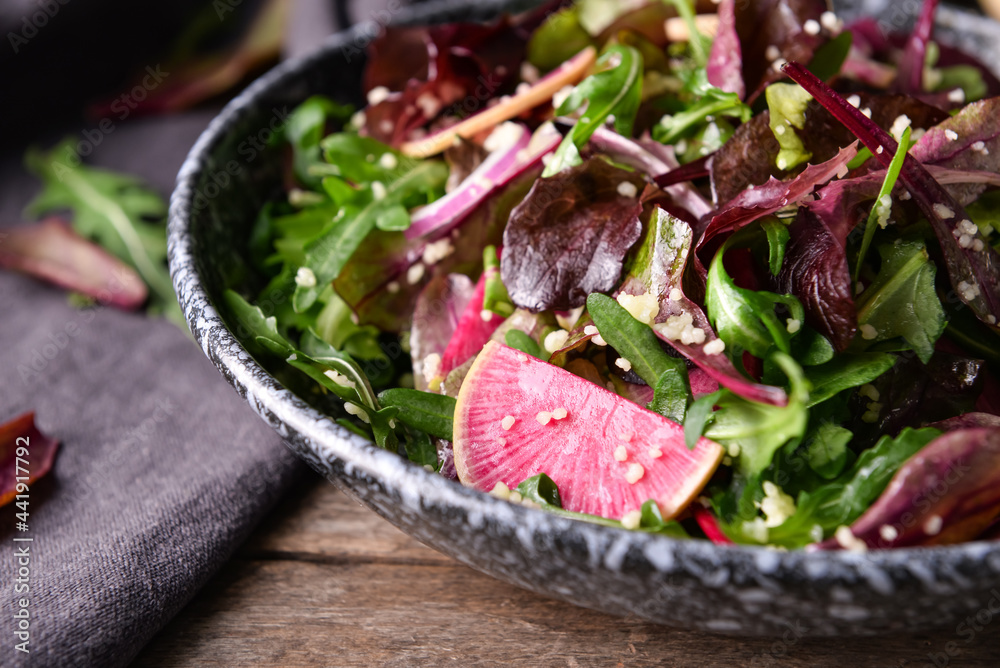 Bowl with couscous and vegetables on wooden background, closeup