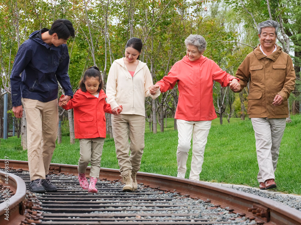 A happy family of five walking outdoors