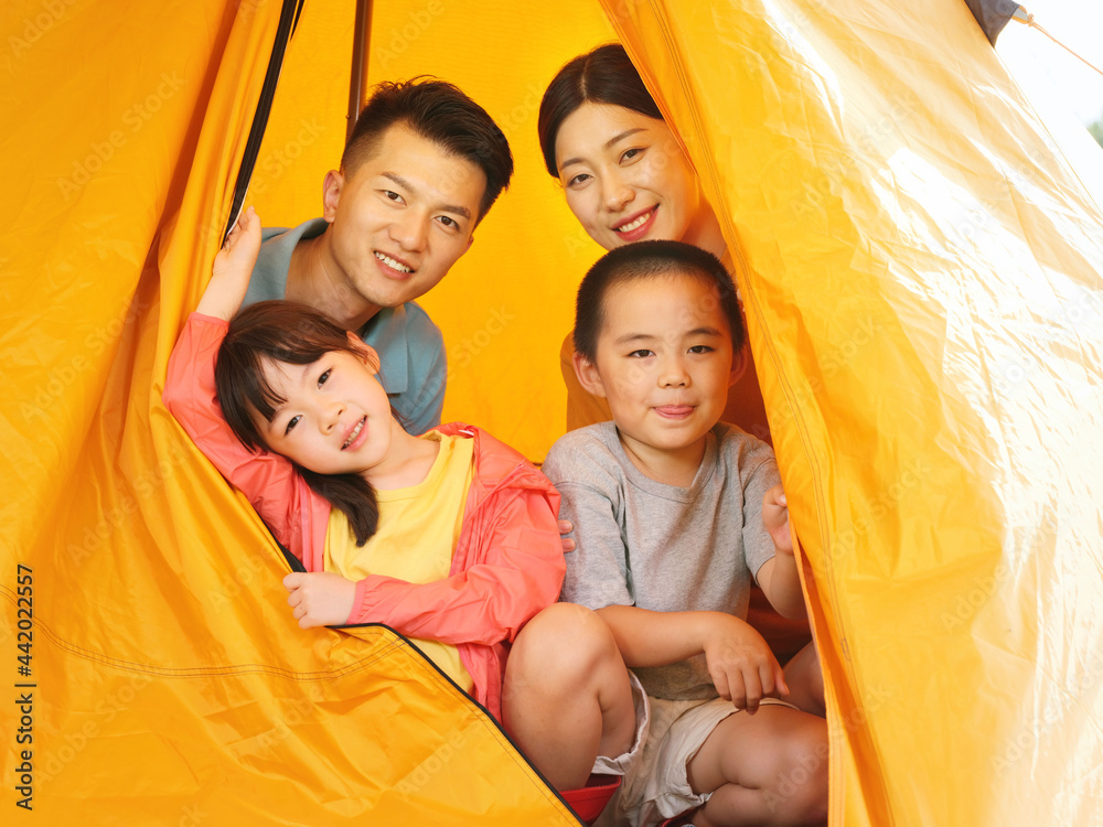 A Happy family of four in tent