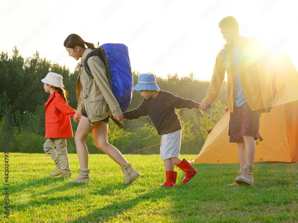 A Happy family of four outdoor hiking