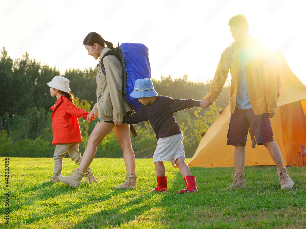 A Happy family of four outdoor hiking