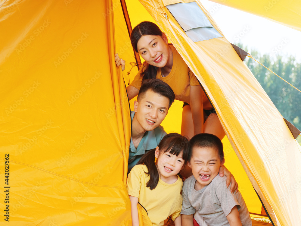 A Happy family of four in tent