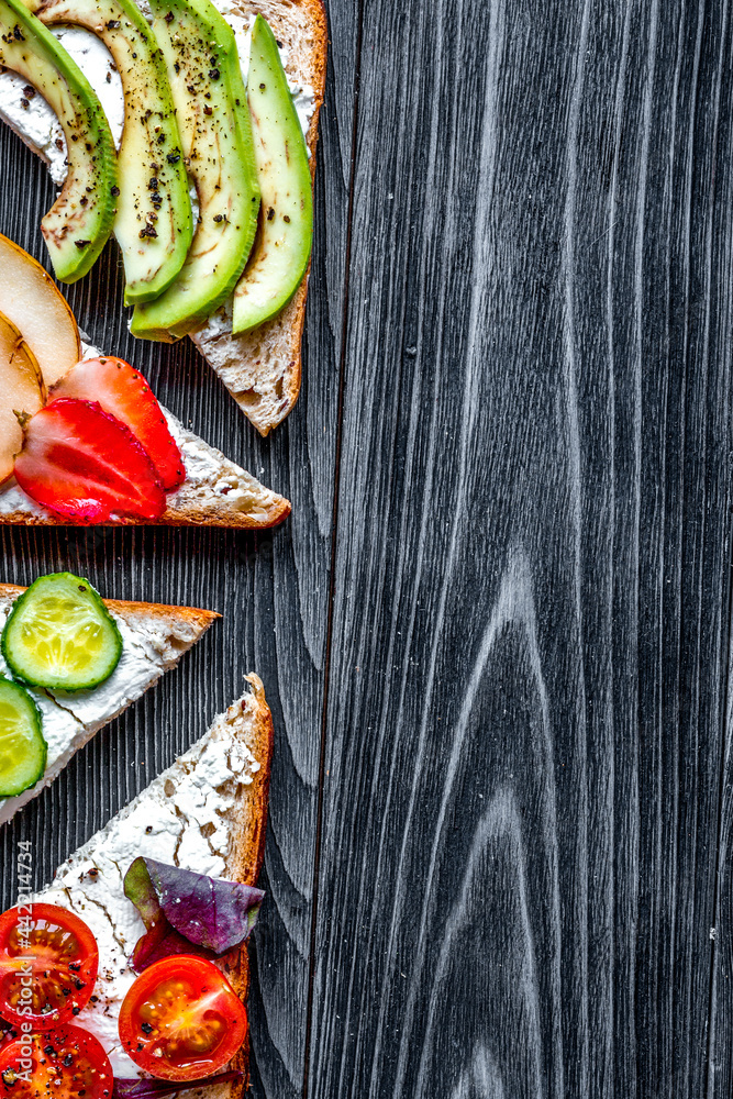 healthy breakfast with sandwiches set on dark wooden background top view mockup