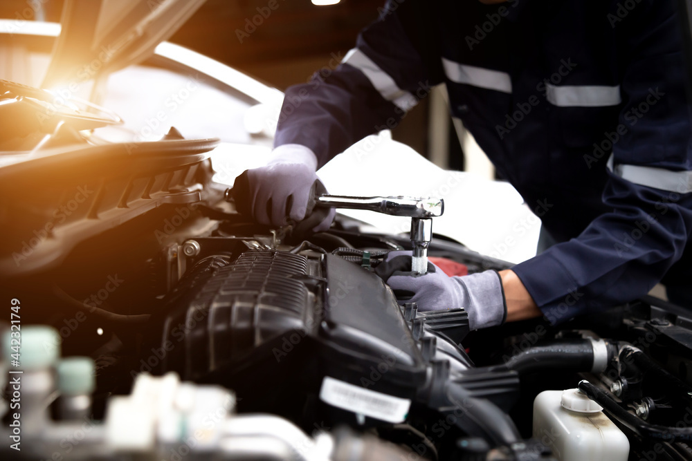 Auto mechanic working on car engine in mechanics garage.Repair service,car service, repair, maintena