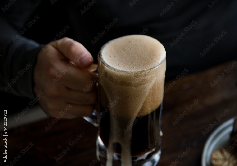 Overflowing pint of beer