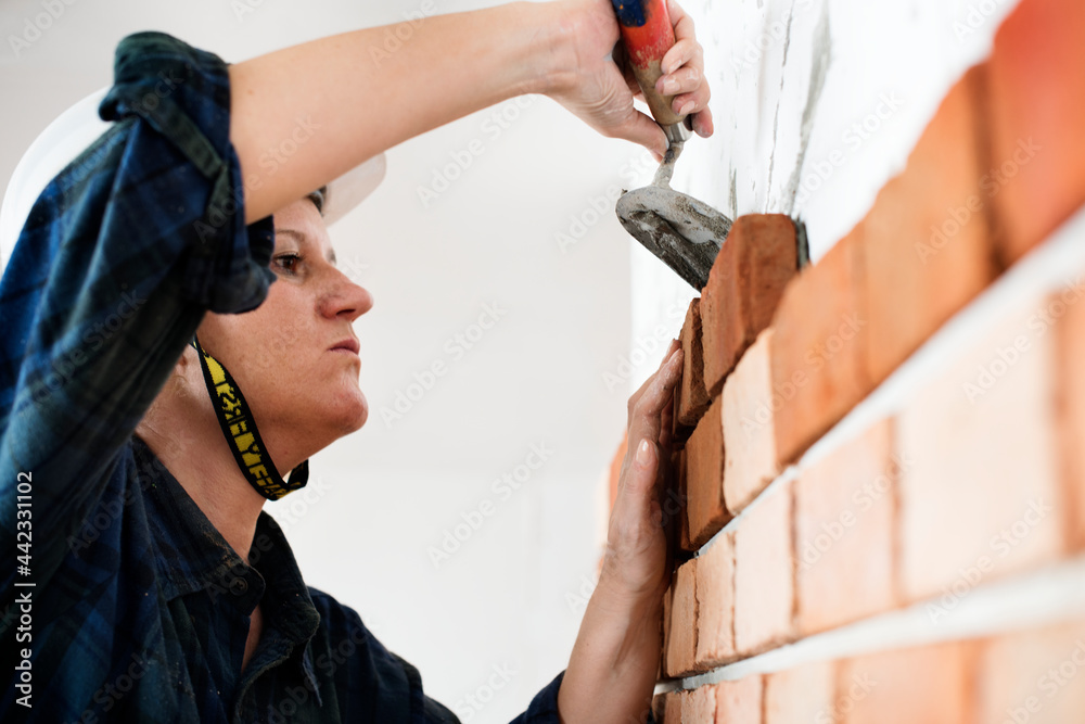 Constructor construction repair plastering on the wall