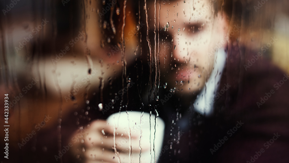 Thoughtful man looking out the window