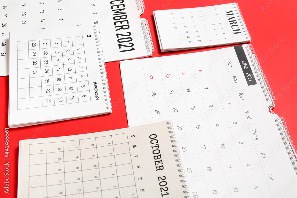 Flip paper calendars on color background, closeup